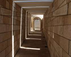 The Lonely Path is a long, somber, and beautiful hallway. Walking down this path one can hear an audio recording of children chanting in Hebrew, sound